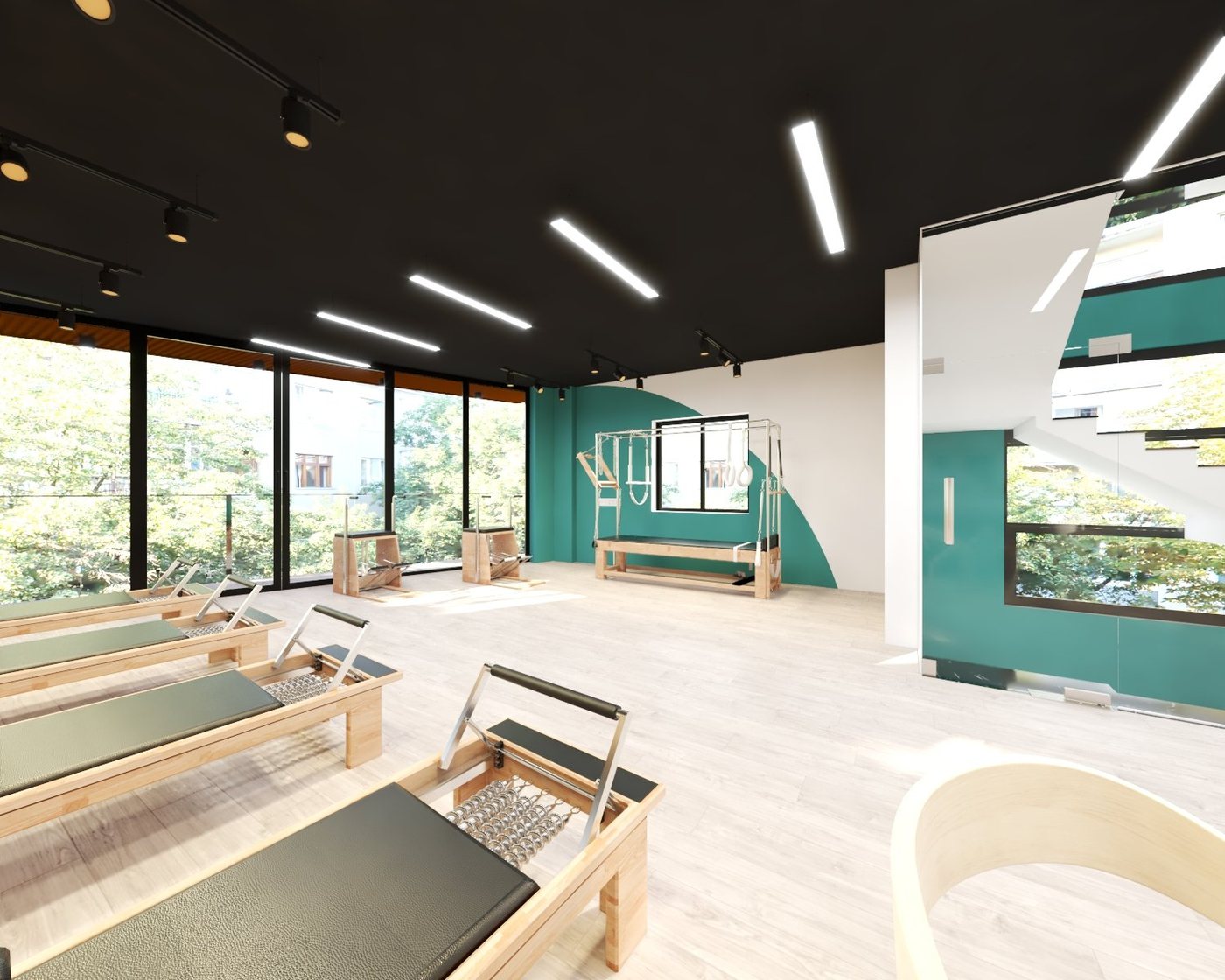 Sàn vân gỗ trong studio Pilates — máy Reformer không thả tạ nên ưu tiên cảm giác ấm và sạch.